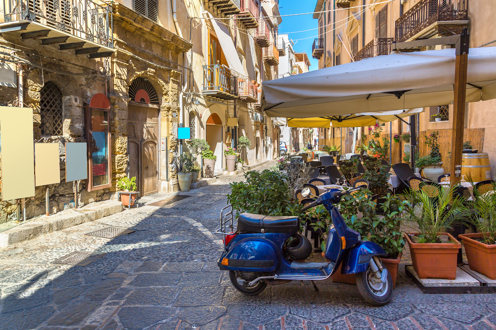An italian town with a moped and plants for the bella mansions wedding venue blog