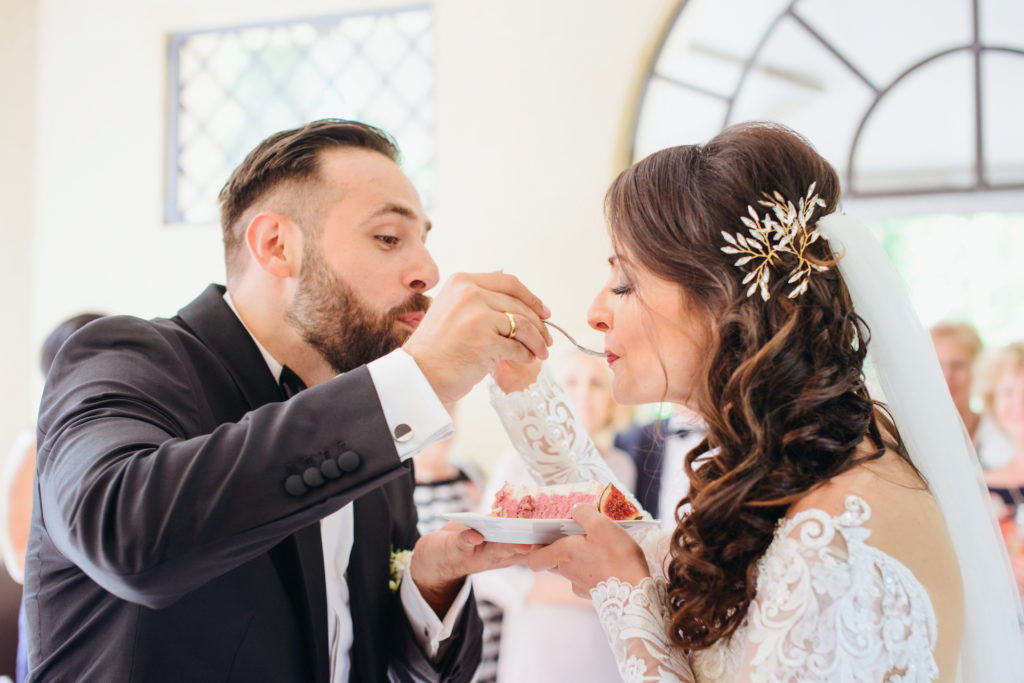 bride and groom feeding each other wedding dessert for bella mansions blog on alternative wedding cakes